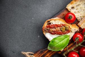 sun-dried tomato bruschetta healthy meal food snack on the table copy space food background rustic top view keto or paleo diet veggie vegan or vegetarian food photo