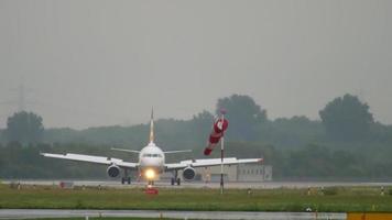 DUSSELDORF, GERMANY JULY 24, 2017 - Airberlin Etihad Airways Airbus 320 D ABDU Moving forward livery crossing runway after landing at rain. Dusseldorf airport, Germany video