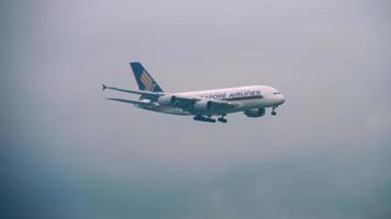 CHANGI, SINGAPORE NOVEMBER 25, 2018  - Singapore Airlines Airbus A380 with condensation plume approaching over the bay before landing in Changi Airport, Singapore video