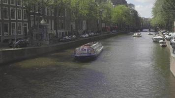 AMSTERDAM, THE NETHERLANDS JULY 28, 2017 - The excursion cruise ship on the canal in Amsterdam video