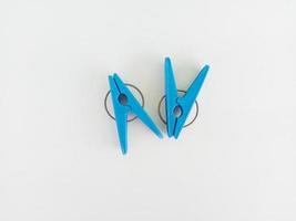 Blue clothes hanger clips on white background image photo