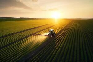 Agricultural field, the tractor cultivates crops, the view from above. photo