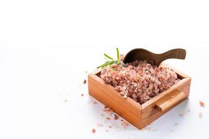 Himalayan pink salt on wooden box isolated on white background with copyspace photo