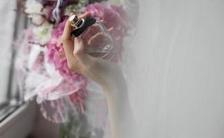 lady with flowers and bottle perfume photo