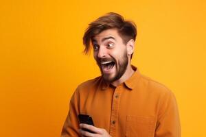 A man with a surprised expression is holding a phone in his hands. photo