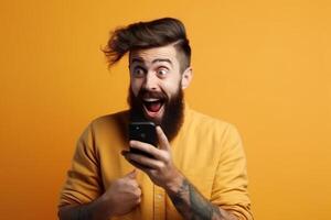 A man with a surprised expression is holding a phone in his hands. photo