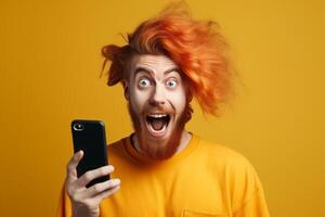 A man with a surprised expression is holding a phone in his hands. photo