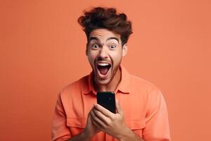 A man with a surprised expression is holding a phone in his hands. photo