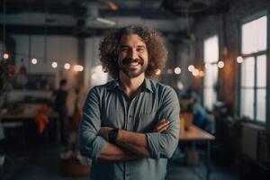 Portrait of smiling businessman standing with arms crossed in creative office. photo