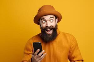 A man with a surprised expression is holding a phone in his hands. photo