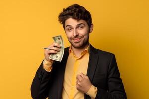 happy young businessman holding dollar banknotes and looking at camera photo