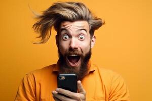 A man with a surprised expression is holding a phone in his hands. photo