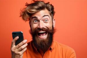 A man with a surprised expression is holding a phone in his hands. photo