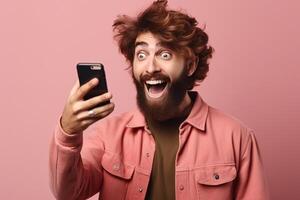 A man with a surprised expression is holding a phone in his hands. photo