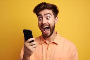 A man with a surprised expression is holding a phone in his hands. photo