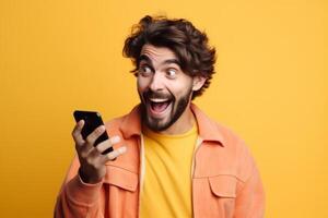 A man with a surprised expression is holding a phone in his hands. photo