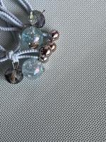 Beautiful beads on grey texture background photo