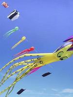 Blue sky with colorful kites in the shape of marine animal photo