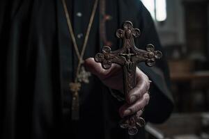 Church priest holds religious cross in hands. photo