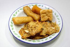 Gorengan is a typical snack from Indonesia. consisting of bakwan risol, tofu. This food is usually sold by street vendors at cheap prices. photo