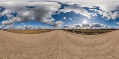 spherical 360 hdri panorama on gravel road with clouds on blue sky in equirectangular seamless projection, use as sky replacement in drone panoramas, game development as sky dome or VR content photo