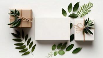 Craft gift boxes with green branches and leaves. Flat lay mock up. photo