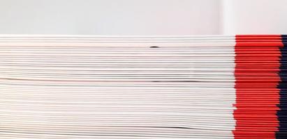 Close up pattern and line of white, red and blue spine or saddle book are sorting and stacking for background with above space. Art group of object, Education and Library concept photo