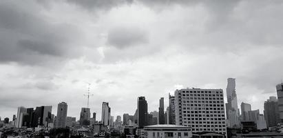 Group of high buildings with sky and cloud background in the center of Bangkok, Thailand with black and white style. Cityscape in monochrome tone. photo