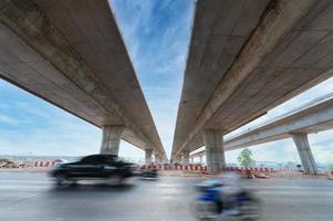 Construction of asphalt highways and overpasses in Asia, view of road junction against the sky photo