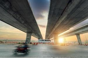 Construction of asphalt highways and overpasses in Asia, view of road junction against the sky photo