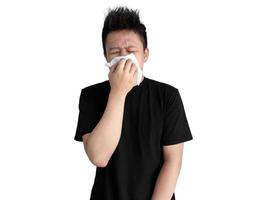 Indonesian man in black shirt blowing his nose with white tissue paper photo