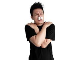 Sick man expression shivering with cold with tissue in nose isolated on white background photo