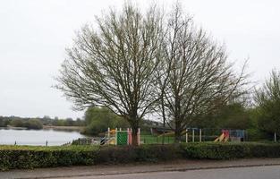 Beautiful Low Angle View of Caldecotte Lake Park and Pub with Restaurant. The Image Was Captured on 09-April-2023 During Cloudy Sunset with Cold Weather and Winds. photo