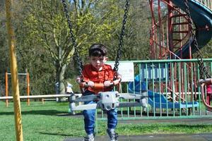 Cute Asian Pakistani Baby Ahmed Mustafain Haider is Enjoying The Beautiful Sunny Day at Wardown Public Park of Luton Town of England UK. Image Was Captured on 03-April-2023 photo