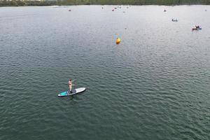 beautiful View of Willen Lake Park with Local and Tourist Public Enjoying the Beauty of Lake and Park by Walking Around with Their Families. Footage Was Captured on 09-April-2023 at Milton Keynes UK photo