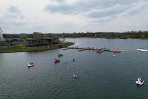 beautiful View of Willen Lake Park with Local and Tourist Public Enjoying the Beauty of Lake and Park by Walking Around with Their Families. Footage Was Captured on 09-April-2023 at Milton Keynes UK photo