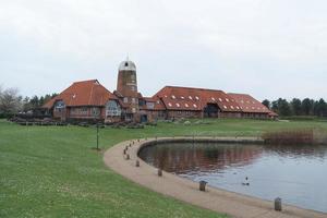 Beautiful Low Angle View of Caldecotte Lake Park and Pub with Restaurant. The Image Was Captured on 09-April-2023 During Cloudy Sunset with Cold Weather and Winds. photo