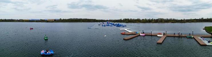 beautiful View of Willen Lake Park with Local and Tourist Public Enjoying the Beauty of Lake and Park by Walking Around with Their Families. Footage Was Captured on 09-April-2023 at Milton Keynes UK photo