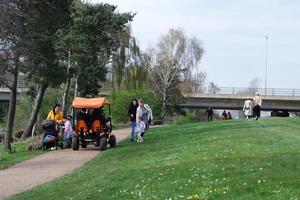 Low Angle View of Willen Lake Park with Local and Tourist Public Enjoying the Beauty of Lake and Park by Walking Around with Their Families. Footage Was Captured on 09-April-2023 at Milton Keynes UK photo