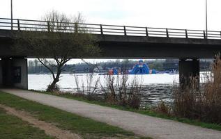 Low Angle View of Willen Lake Park with Local and Tourist Public Enjoying the Beauty of Lake and Park by Walking Around with Their Families. Footage Was Captured on 09-April-2023 at Milton Keynes UK photo