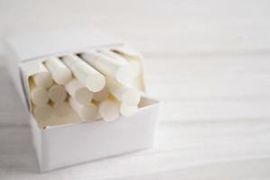 Cigarette in pack, roll tobacco in paper with filter tube, No smoking concept. photo