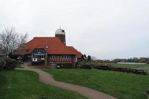 Beautiful Low Angle View of Caldecotte Lake Park and Pub with Restaurant. The Image Was Captured on 09-April-2023 During Cloudy Sunset with Cold Weather and Winds. photo