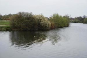 Beautiful Low Angle View of Caldecotte Lake Park and Pub with Restaurant. The Image Was Captured on 09-April-2023 During Cloudy Sunset with Cold Weather and Winds. photo