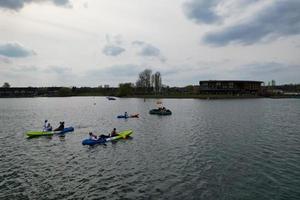 beautiful View of Willen Lake Park with Local and Tourist Public Enjoying the Beauty of Lake and Park by Walking Around with Their Families. Footage Was Captured on 09-April-2023 at Milton Keynes UK photo
