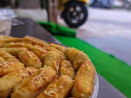 A close up of Kaasstengels, Kastengel or Cheesecake. pastries that are usually served during Eid in Indonesia photo