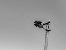 Power electric pole with line wire on light background close up photo