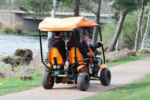 Low Angle View of Willen Lake Park with Local and Tourist Public Enjoying the Beauty of Lake and Park by Walking Around with Their Families. Footage Was Captured on 09-April-2023 at Milton Keynes UK photo