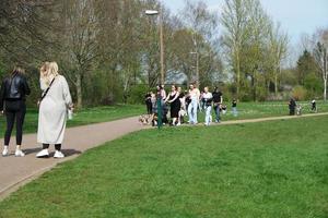 Low Angle View of Willen Lake Park with Local and Tourist Public Enjoying the Beauty of Lake and Park by Walking Around with Their Families. Footage Was Captured on 09-April-2023 at Milton Keynes UK photo