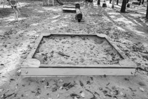 Photography on theme empty wooden sandbox with sand for kids photo