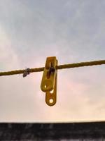 Flies hanging on a clothespin on a string. Blurred and bokeh background photo